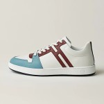 Hermes H242933Z H69440 White & Blue Sneakers – Side Detail of Iconic Stripes Hermes Mens Sneaker H242933Z H69440 in White and Blue – Front View of Luxury Sneakers with Navy Blue Stripes