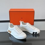 Hermes H251121Z 02360 White Sneakers – Iconic H Logo on Heel Hermes Mens Sneaker H251121Z 02360 in White – Front View of Luxury Fashion Sneakers with Orange H Logo