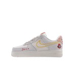 Nike Air Force 1 Low WMNS "Just Do It" sneakers in beige with yellow stitching and graphic details