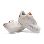 Nike Air Force 1 Low WMNS "Just Do It" sneakers in beige with yellow stitching and graphic details