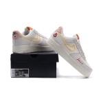 Nike Air Force 1 Low WMNS "Just Do It" sneakers in beige with yellow stitching and graphic details