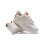 Nike Air Force 1 Low WMNS "Just Do It" sneakers in beige with yellow stitching and graphic details