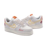 Nike Air Force 1 Low WMNS "Just Do It" sneakers in beige with yellow stitching and graphic details