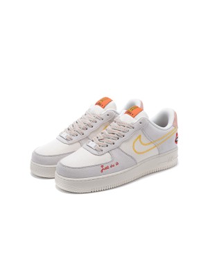 Nike Air Force 1 Low WMNS "Just Do It" DQ7656-100 - 노란 스티치와 재미있는 그래픽 디테일이 돋보이는 여성용 베이지 스니커즈