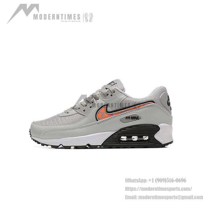 Grey Nike Air Max 90 sneakers with black and orange Swoosh accents, showcasing bold contrast and modern style.