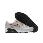 Grey Nike Air Max 90 sneakers with black and orange Swoosh accents, showcasing bold contrast and modern style.