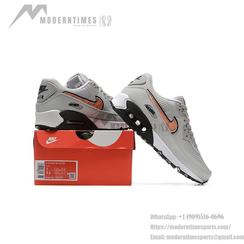 Grey Nike Air Max 90 sneakers with black and orange Swoosh accents, showcasing bold contrast and modern style.