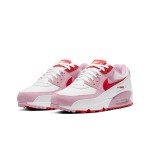 White Nike Air Max 90 Valentine's Day sneakers with pink overlays and red swoosh.