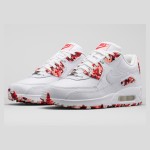 Close-up of Nike Air Max 90 813150-100 with red camouflage overlays and white leather upper