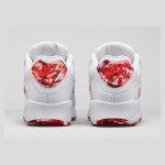 Close-up of Nike Air Max 90 813150-100 with red camouflage overlays and white leather upper